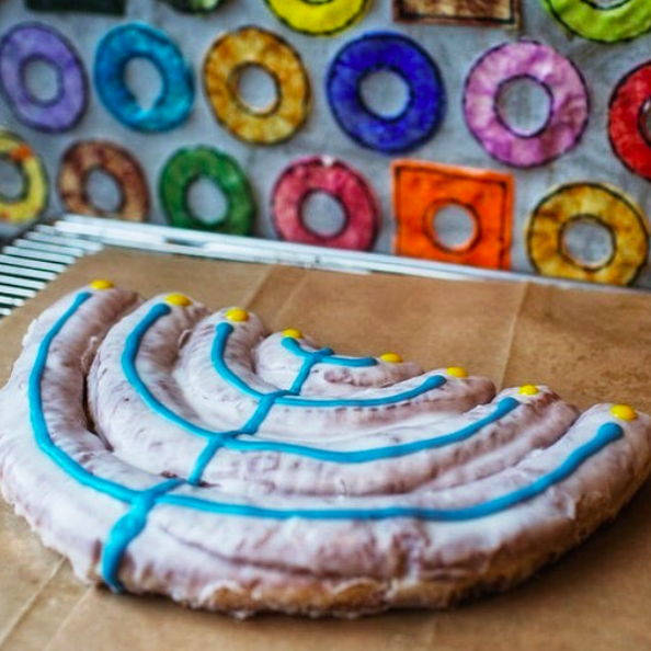 a menorah made of donut on a brown paper bag