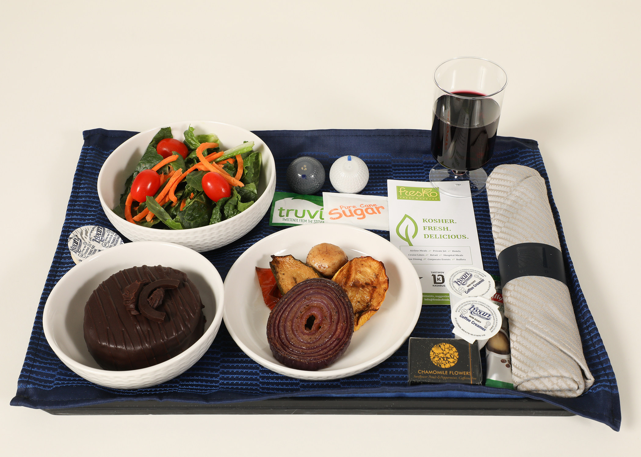 Kosher airline meal tray with sealed dishes on a flight to Tel Aviv