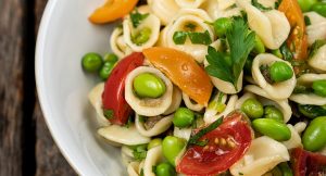 a bowl of pasta with fresh vegetables
