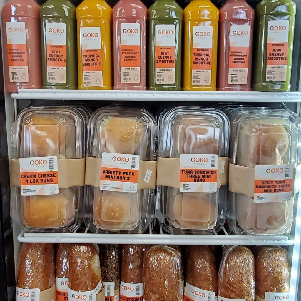 sandwiches and juices in a refrigerator display