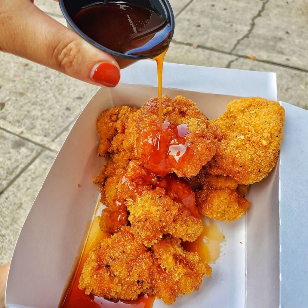 sauce pouring over chicken nuggets