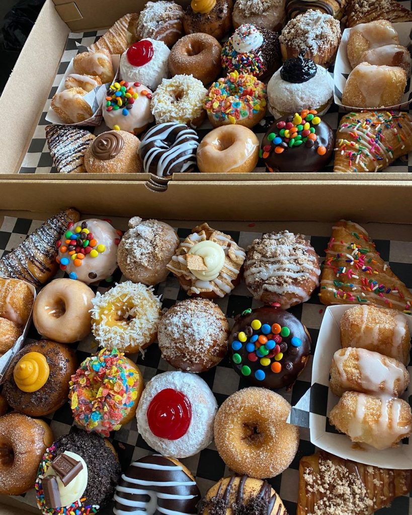 2 boxes full of donuts with crazy toppings