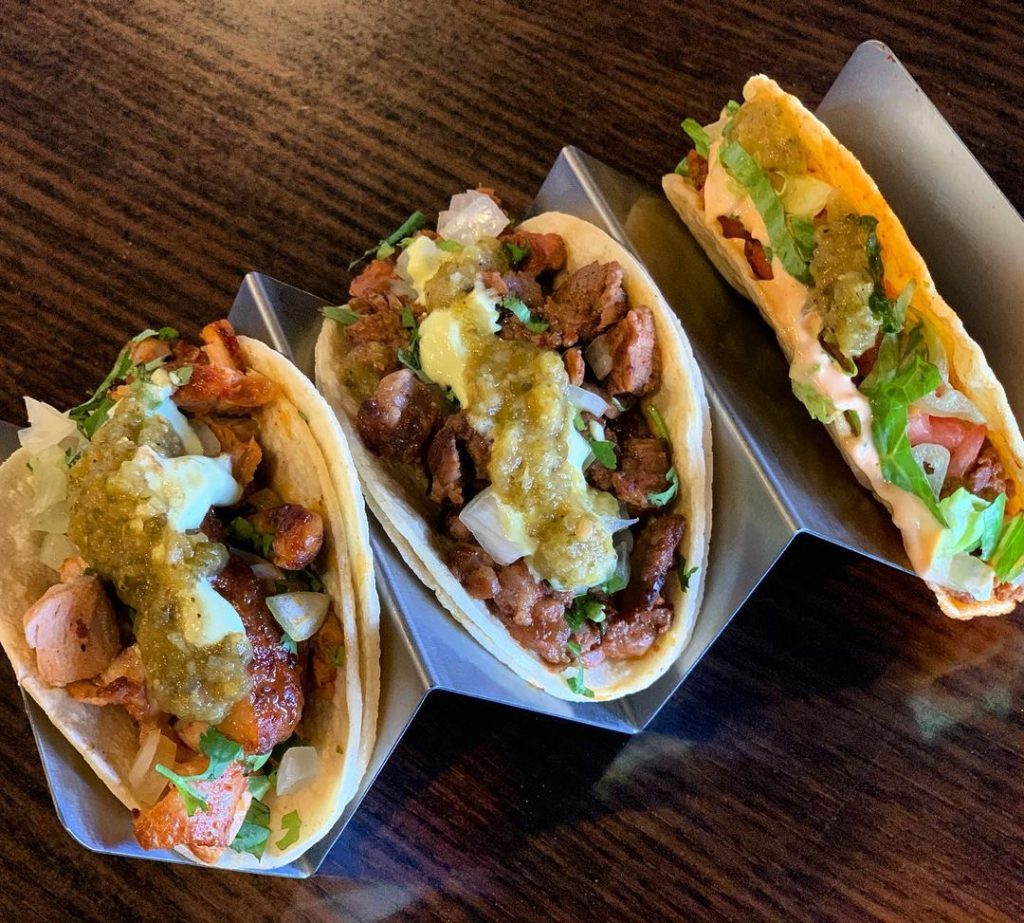 three tacos in a taco holder