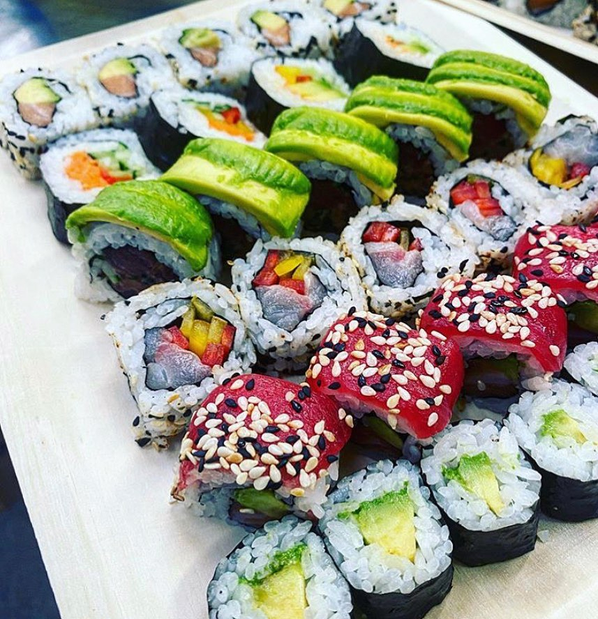 five sushi rolls laid out on a plate