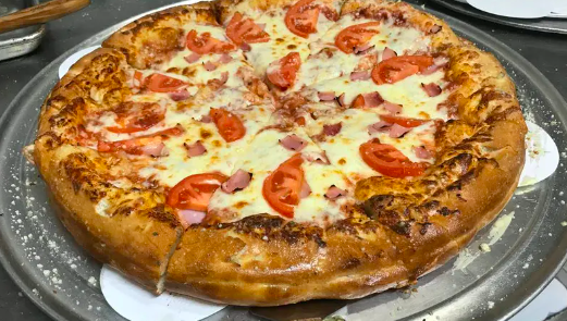 a thick crust pizza with tomato and onion