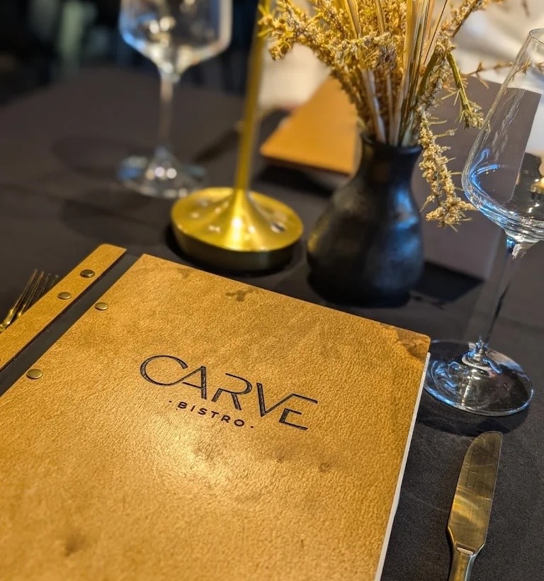 Carve Bistro menu cover on a dining table
