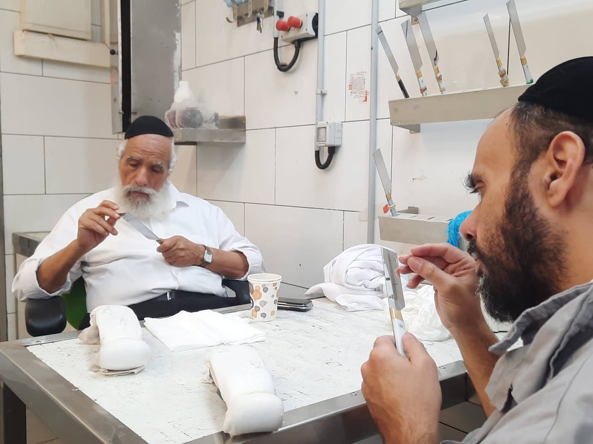 A shochet checks the edge of his chalaf at the Of Yerushalayim slaughterhouse in Jerusalem
