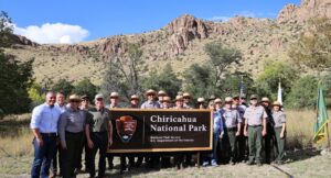 Interior Secretary Doug Burgum, Rep. Juan Ciscomani and National Park Service staff with the new Chiricahua National Park sign (NPS photo)