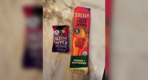 Skinny Dipped dark chocolate peanut butter cup and Solely organic mango raspberry fruit jerky